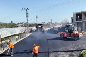 Mersin Büyükşehir Belediyesi ekipleri Mezitli'de sıcak asfalt serim çalışması yapıyor