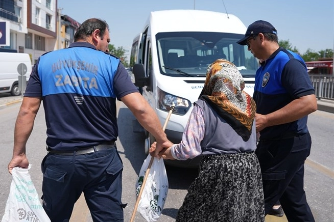 Denizli zabıta ekipleri, dilencilere yönelik denetimler sırasında bir kişiyi işlem yapmak üzere zabıta binasına götürüyor.