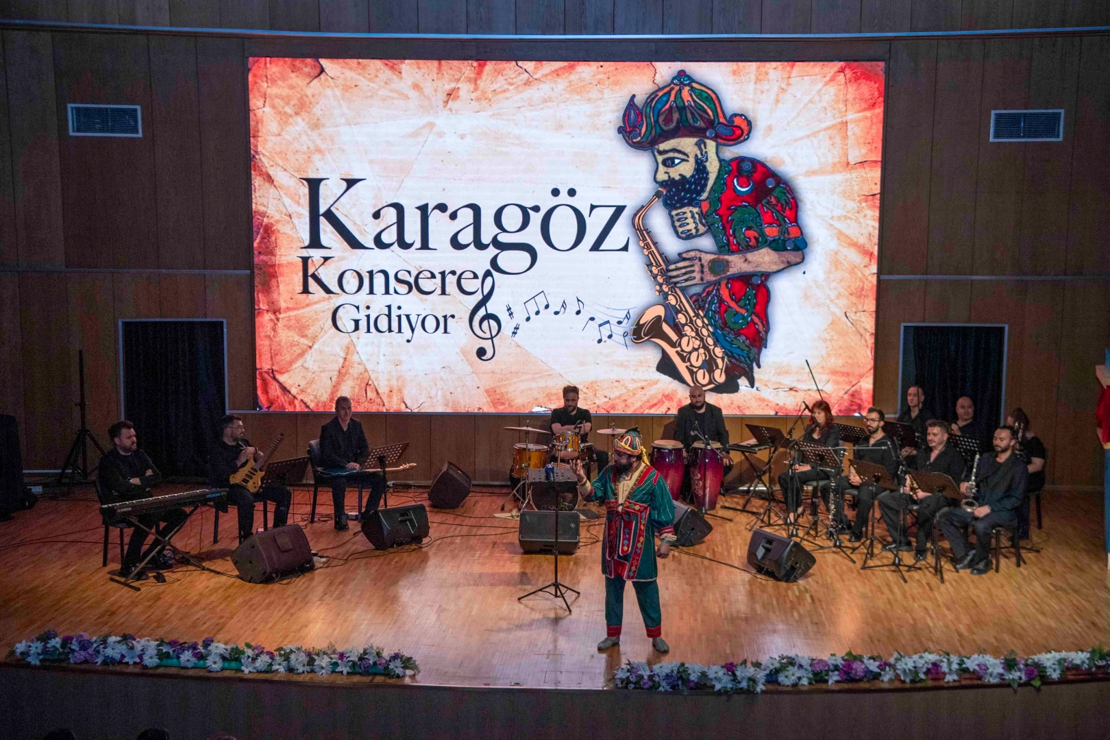 Çocuklar Karagöz ve Hacivat karakterleriyle dolu bir müzikal gösterisini izliyor